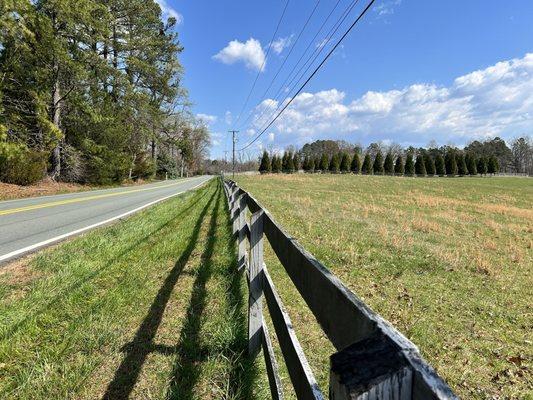 BOARD FENCE alongside 40mph strait away 2 lane route 676