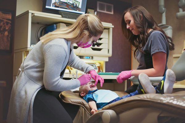 Dr. Frankie & assistant Tiffany working on a young patient!