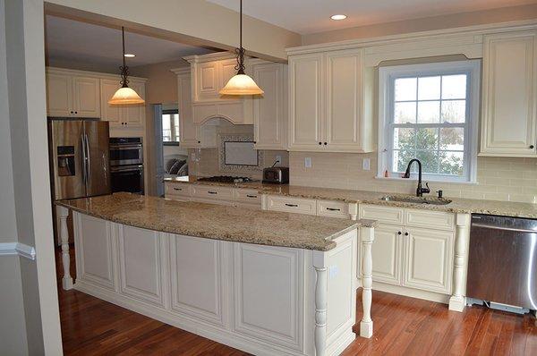 Antique white with posts, false doors, valance over the sink base to show less can be more!