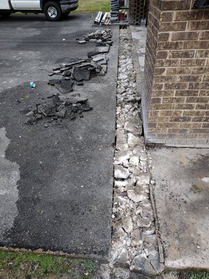 Driveway drain installation. Demolition of asphalt and concrete.