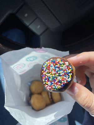 Chocolate covered donut holes with sprinkles