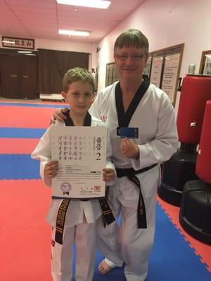 Aidan receiving his kukkiwon certificate from grandmaster Ray