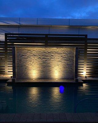 Amazing Water Wall flowing into your Pool. Included with lighting and outdoor fire pits.