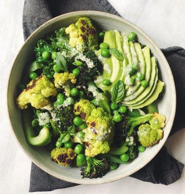 Green vegetable Buddha bowl with basil tahini creama