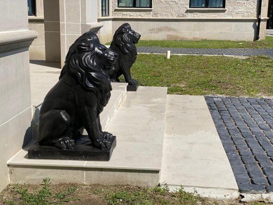 2 Black Lions Statues next to a customers House