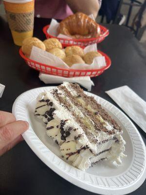 Coconut white chocolate cake. 2 orders of pão de queijo. One sweet bread croissant.