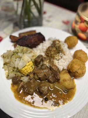 Try our savory curry goat with white rice, phoularie, mixed veggies and sweet plantains.