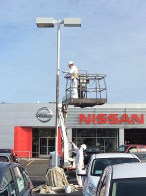 GCPAINTING giving Crown Nissan car lot lights a fresh coat of High performance paint.