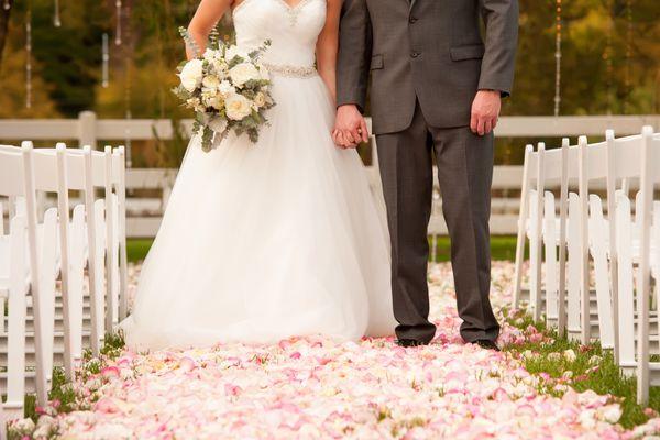 Rose petals lining the aisle for the wedding ceremony.