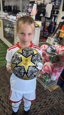 At our favorite shop sporting her white uniform.