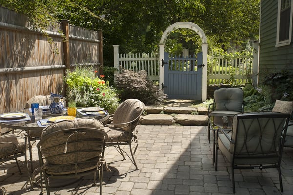 Courtyard patio designed for family in Needham. Patio includes new stonework, containers, and stone fountain.