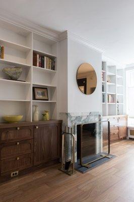 The fireplace and bookcases were renovated with new custom stone and millwork by Eclectic Builders.