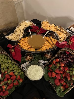 Assorted gourmet cheese display with fresh strawberries