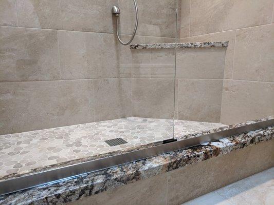 Granite curb and shower seat in small bath space