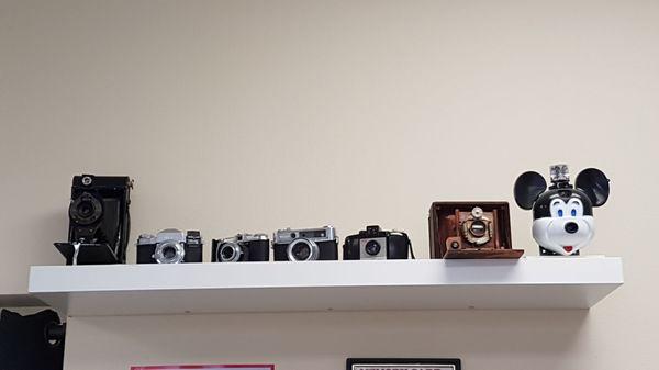 A few of the many cameras showing how photography has advanced.