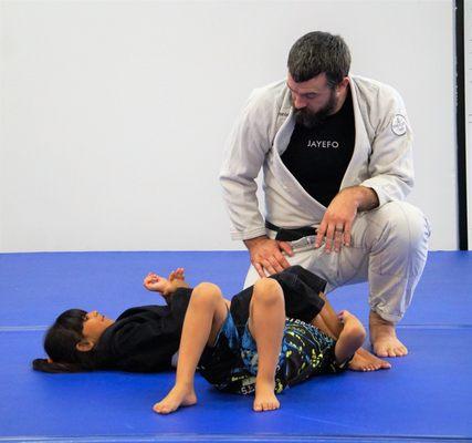 Coach Kevin supervising students performing the day's technique