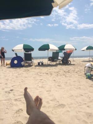 Chairs and umbrellas make for a breezy beach day with the Atlantic rolling in.