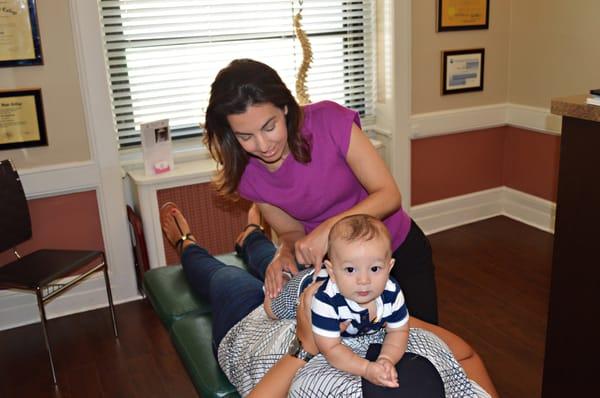 Dr. Dina adjusting an infant.