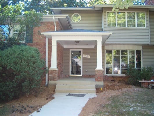 Craftsman style portico w/ low pitched hip roof, tapered columns and brick bases in Bethesda, MD.