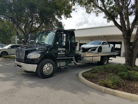 Exotics are towed properly on flatbeds with ramping and nylon tie downs