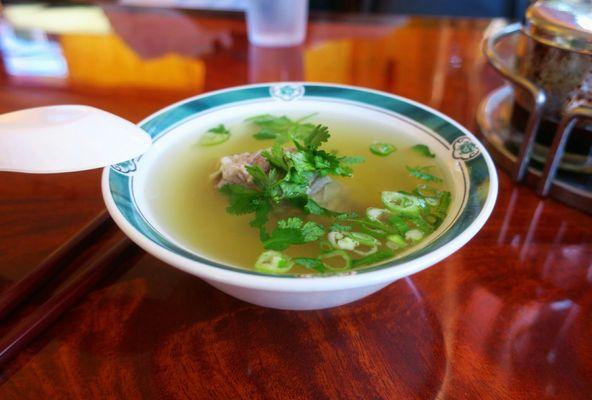 The broth on the side. Each with a piece of the beef