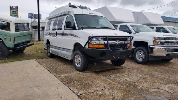 Lifted van with brush guard bumper