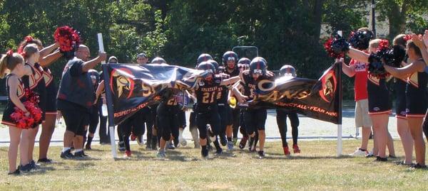 The 12u Upper Cape Spartans team stepping out onto the field during the 2014 season.