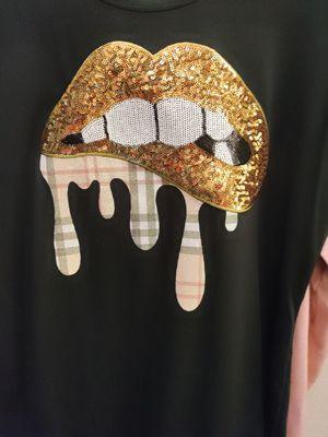 Custom T-shirt with gold sequin lips and Burberry drip.