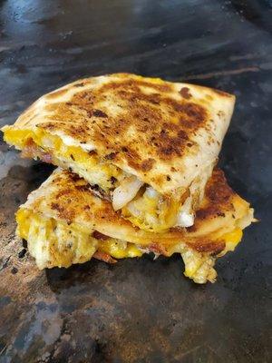 The breakfast quesadilla with scrambled egg, bacon, onion and cheddar cheese