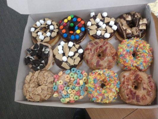 A box of gourmet variety pack of donuts.