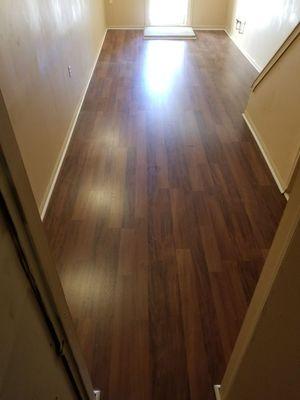 Basement floor leveled and finished with laminate flooring.