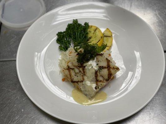 Grilled Snapper topped with citrus Vinaigrette accompanied by rice pilaf broccoli and yellow squash.