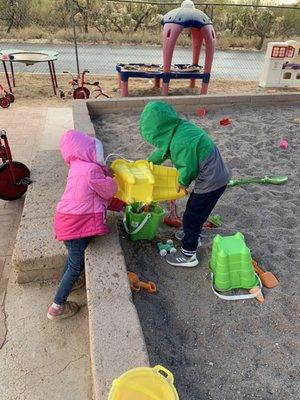 The sand play area is huge and always a great place for teamwork!