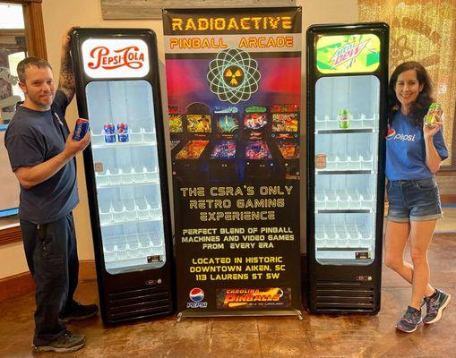 Owners Eric and Erin of Radioactive Pinball Arcade with their sponsor Pepsi fridges