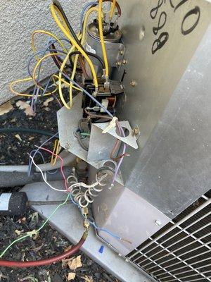 Hot mess of disconnected wires on outdoor AC condenser