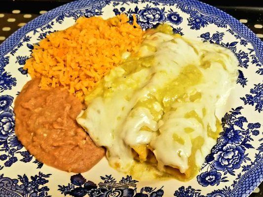 Take out enchiladas suizas served on a plate at home.