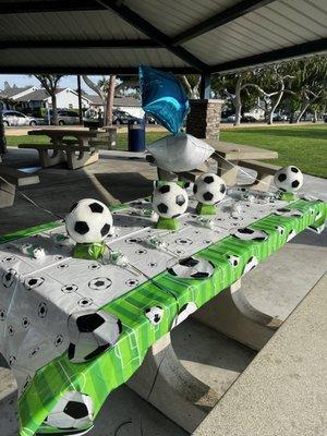 Table cloths, soccer ball piggy banks and marshmallow favors.