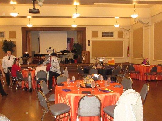 Set up for Halloween themed event. Venue has stage, podium and projector screen available for use.