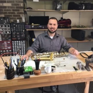 Nick C. ready to repair saxes and strings!