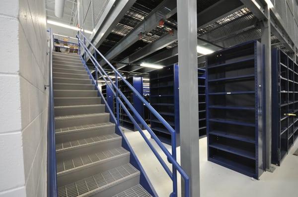 Mezzanine, staircase, and shelving in a parts department.