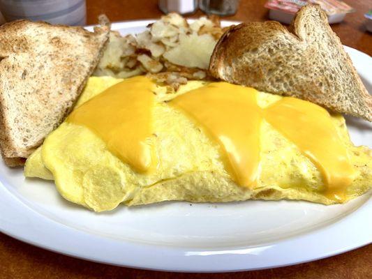 Corned beef hash omelette home fries and toast.