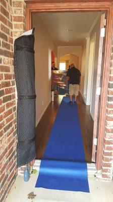 Our movers protecting the customers entryway and wood floors.