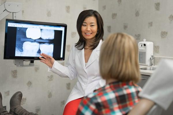 Dr. Lee performing 1-on-1 patient consultation for best patient treatment plan.