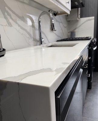 Quartz countertop with waterfall and backsplash