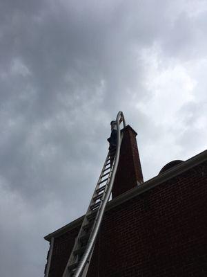 Jeff installing a flue liner for the new furnace vent