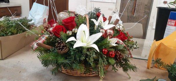 Holiday Wicker Basket with Lilies, Roses, Pine Cones, Greens, and White Willow