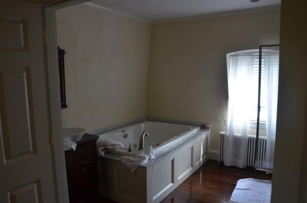 bathroom includes this jacuzzi tub and a large shower.