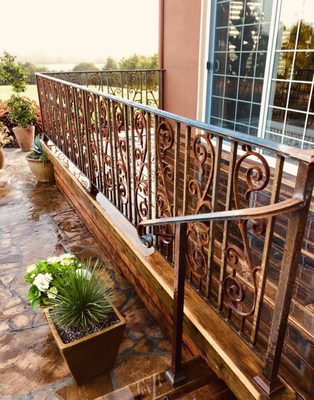 Decorative iron railing with scrolls installed