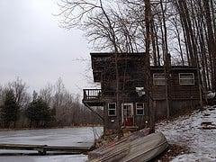 View of the lake and family-sized cabin, down the hill from couple's cabin