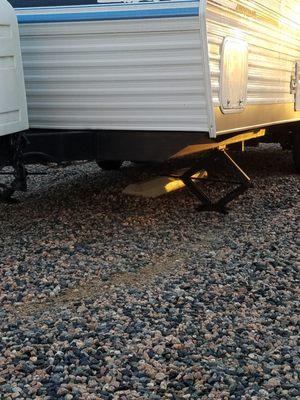 Notice the gravel piled up on the left side of the concrete divider on the left side indicating it was slide underneath my camper.